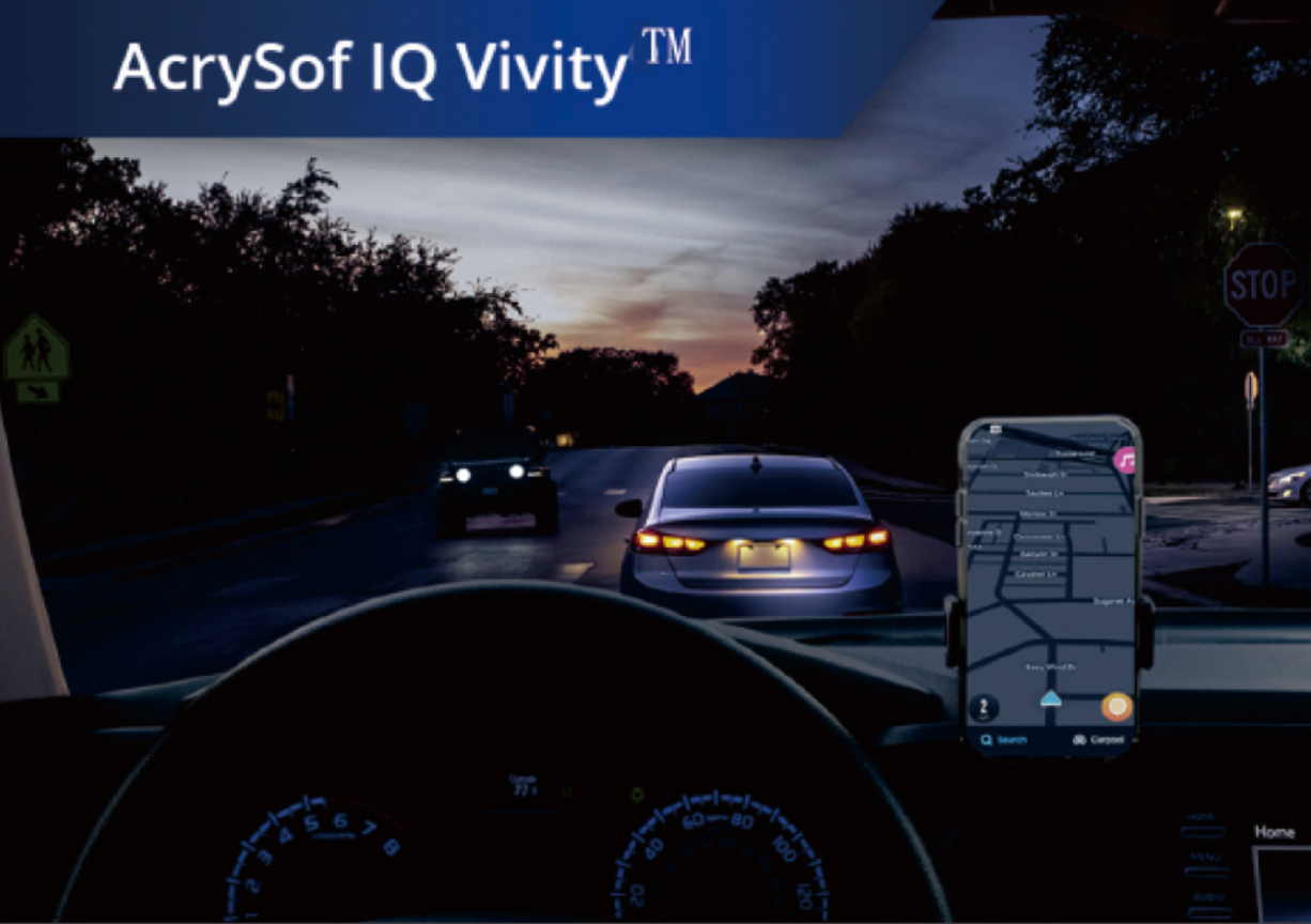 Car on the road in dim lighting with phone set up on the dashboard. White text at the top left corner of this image reads “AcrySof IQ Vivity.”
